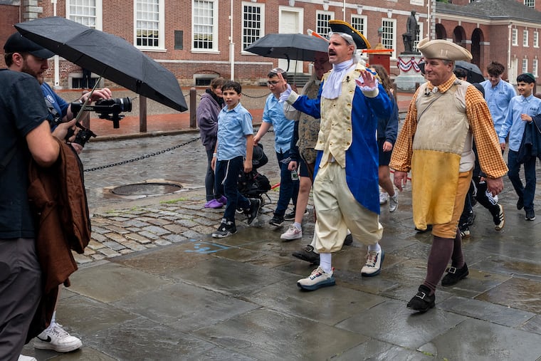 Not quite like the scene where hundreds of kids run behind Sylvester Stallone in Rocky II, field tripping students walk with "Colonists" front of Independence Hall during filming for Barstool Sports.