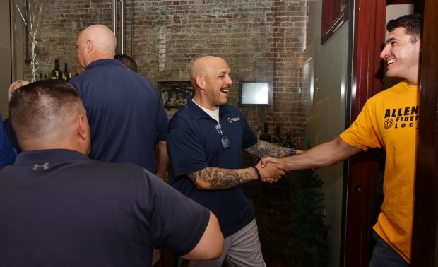 Bethlehem Fire Fighters Union President Lou Jimenez, left, greets his cousin, Allentown firefighter Leroy Bachert Jr., as they wait for former Bethlehem firefighter and Democratic congressional candidate Bob Brooks to arrive at his election party on Primary Day, Tuesday, May 19, 2026, at Artisan in Bethlehem. (Monica Cabrera/The Morning Call)