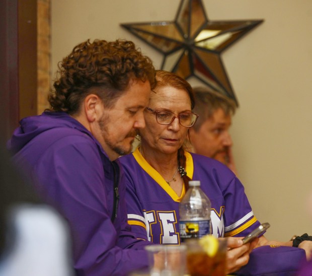 Andi Perez of Philadelphia and Matt Yarnell look at early election results on their cellphones as they wait for former Bethlehem firefighter and Democratic congressional candidate Bob Brooks to arrive at his election party on Primary Day, Tuesday, May 19, 2026, at Artisan in Bethlehem. (Monica Cabrera/The Morning Call)