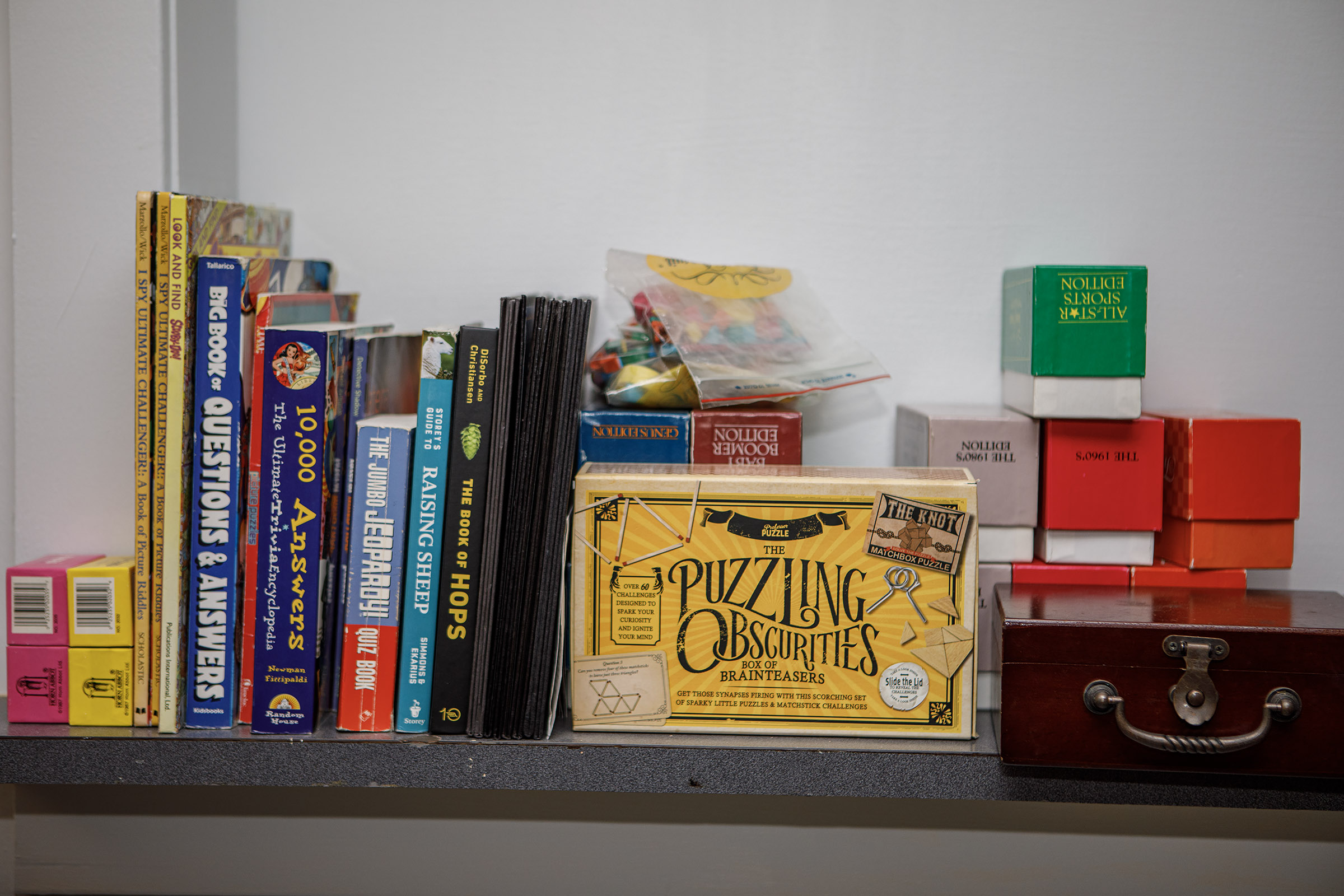 A shelf of books and games in the HiJinx Brewing...