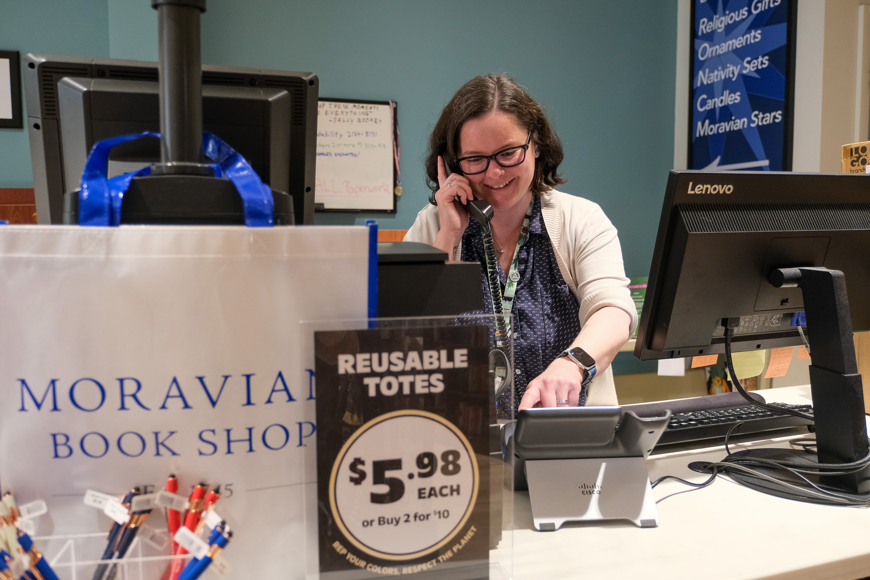 Employee Katie Lerch takes a phone call at the Moravian...