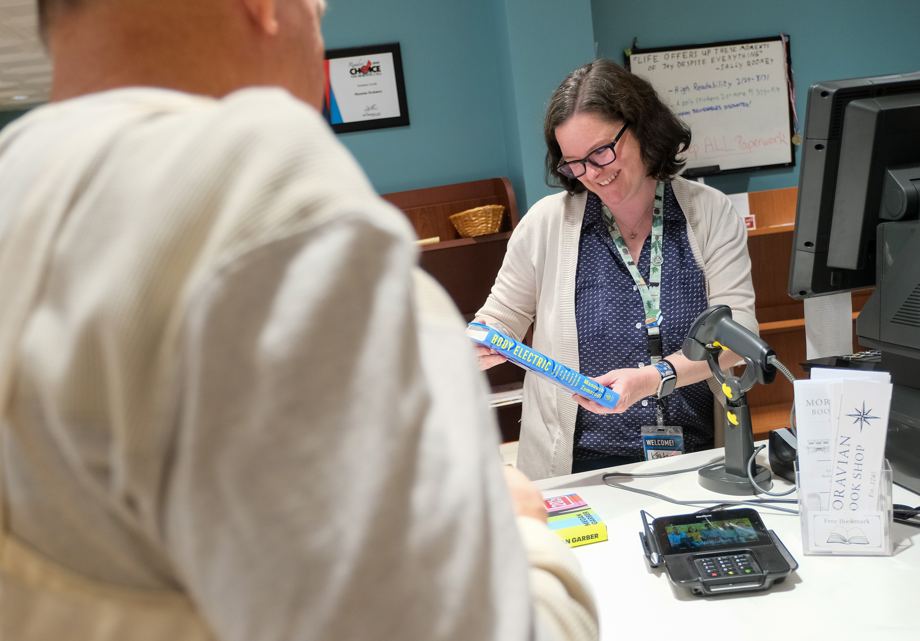 Employee Katie Lerch waits on a customer at the Moravian...