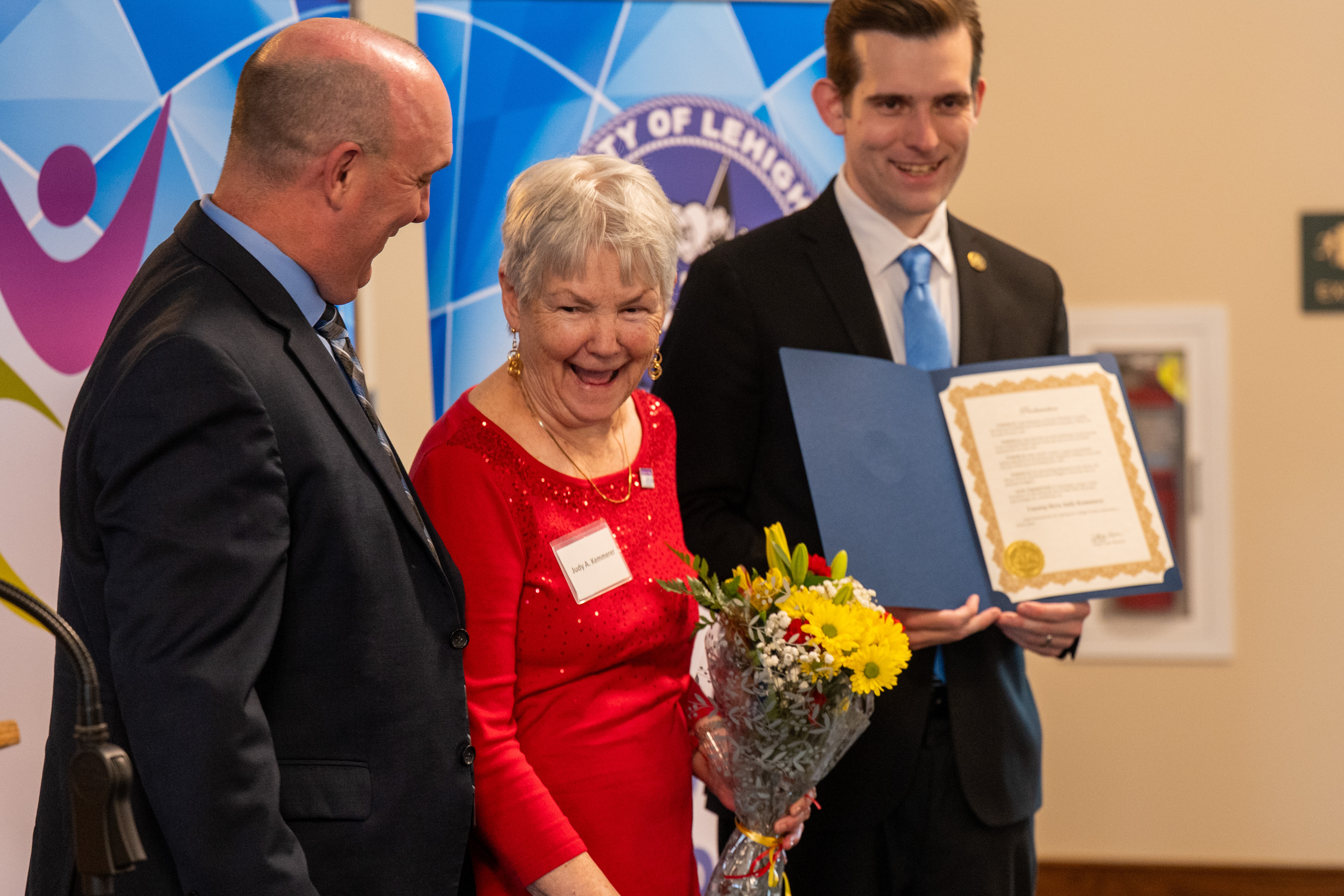 JR Reed of Lehigh County Aging & Adult Services and Lehigh County Executive Josh Siegel present an award to Judy Kemmerer of North Whitehall Township during the 26th annual Unsung Heroes tribute Wednesday, May 13, 2026, at Fellowship Community's Zentz Center in Whitehall Township. The annual tribute recognizes older adults who have enhanced their communities through active engagement, volunteerism and service to others. (Jonathan Broady/Special to The Morning Call)