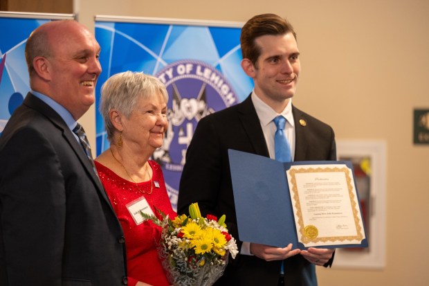 JR Reed of Lehigh County Aging & Adult Services and Lehigh County Executive Josh Siegel present an award to Judy Kemmerer of North Whitehall Township during the 26th annual Unsung Heroes tribute Wednesday, May 13, 2026, at Fellowship Community's Zentz Center in Whitehall Township. The annual tribute recognizes older adults who have enhanced their communities through active engagement, volunteerism and service to others. (Jonathan Broady/Special to The Morning Call)