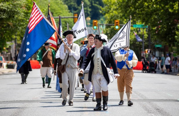 Reenactors walks around Centre Square on Sunday, July 7, 2024, during the annual Easton Heritage Day celebration. (Emma Reed/The Morning Call)