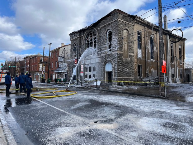 A hose continues dousing water on the Faith Tabernacle House of Prayer on Jan. 8, 2025 on DeKalb Street in Norristown. A fire broke out at the church on Jan. 7, 2025. (Rachel Ravina - MediaNews Group)