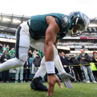 Jan 11, 2026; Philadelphia, PA, USA; Philadelphia Eagles quarterback Jalen Hurts (1) touches the grass as he heads out to the field for warmups prior to an NFC Wild Card Round game against the San Francisco 49ers at Lincoln Financial Field.