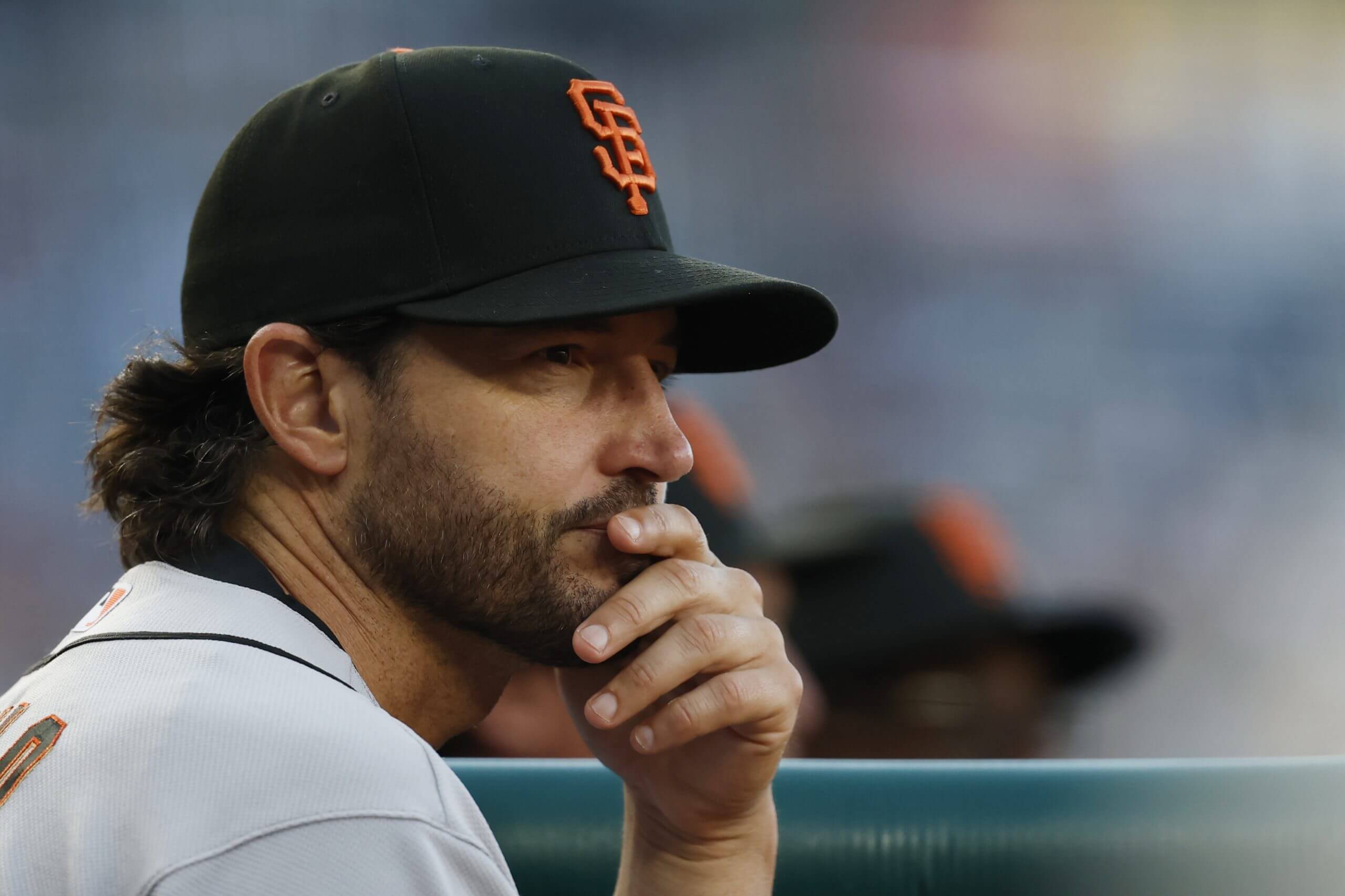 Tony Vitello looks on from dugout.