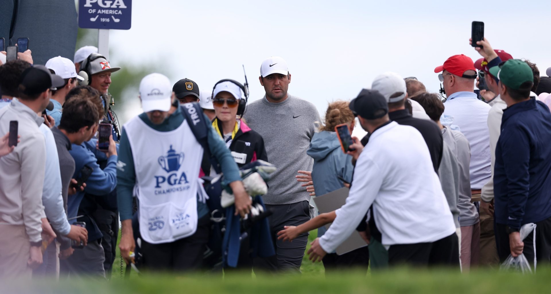 May 14, 2026; Newtown Square, Pennsylvania, USA; Scottie Scheffler walks past fans to the seventh tee during the first round of the PGA Championship golf tournament at Aronimink Golf Club.