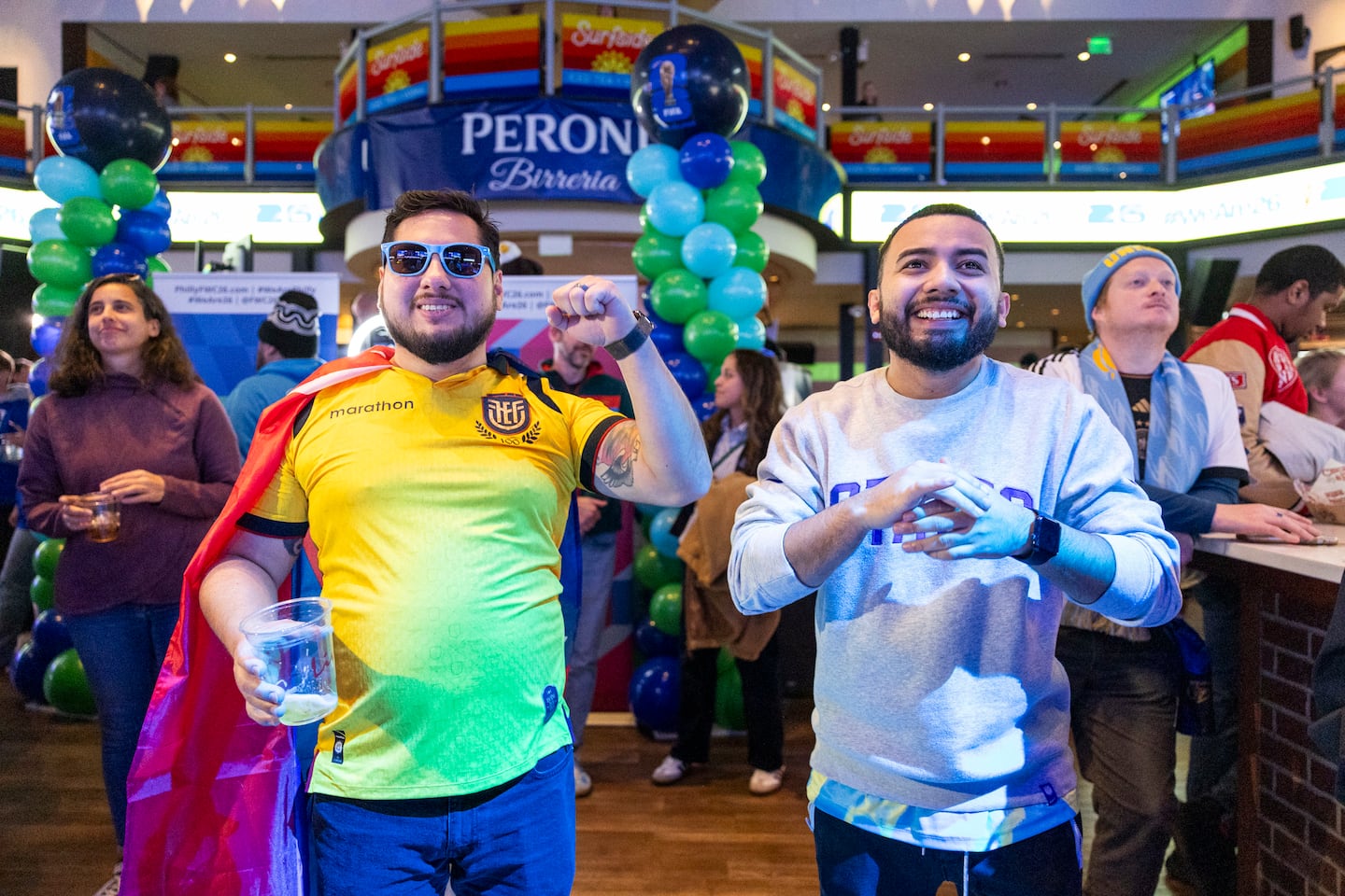 Wilson Velez, 36 (left), and Edwin Martinez watched the second round of draws for the FIFA World Cup at Stateside Live! in Philadelphia in December.