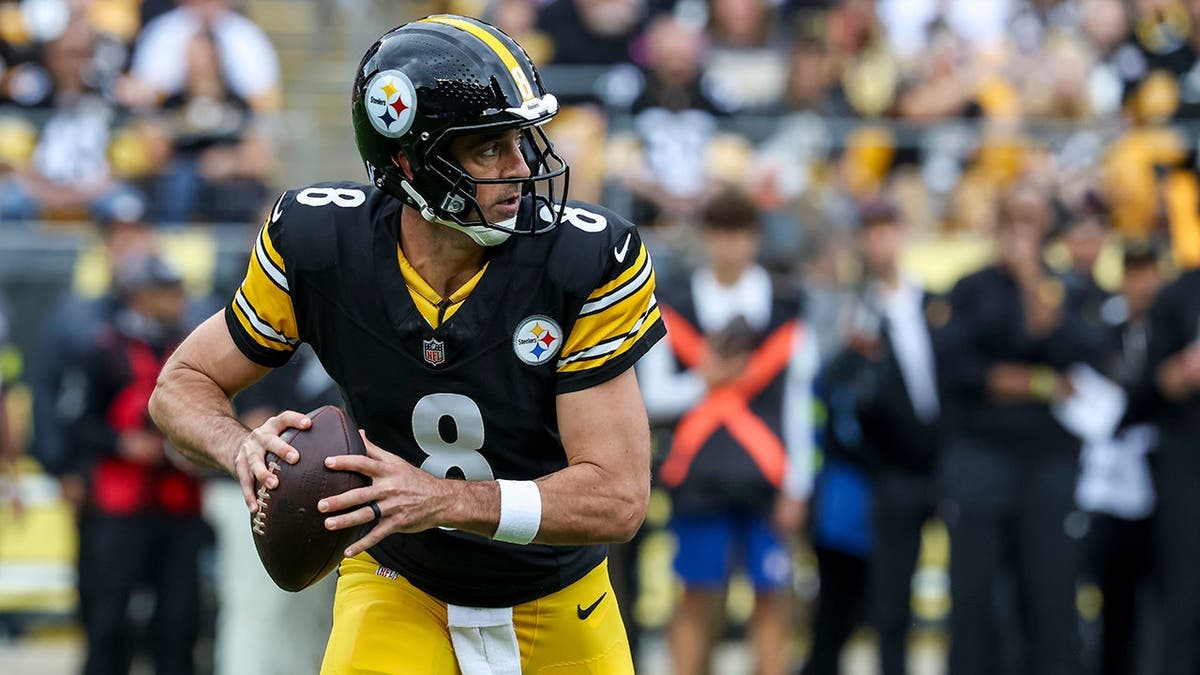 Pittsburgh Steelers quarterback Aaron Rodgers looks to complete a pass at Acrisure Stadium