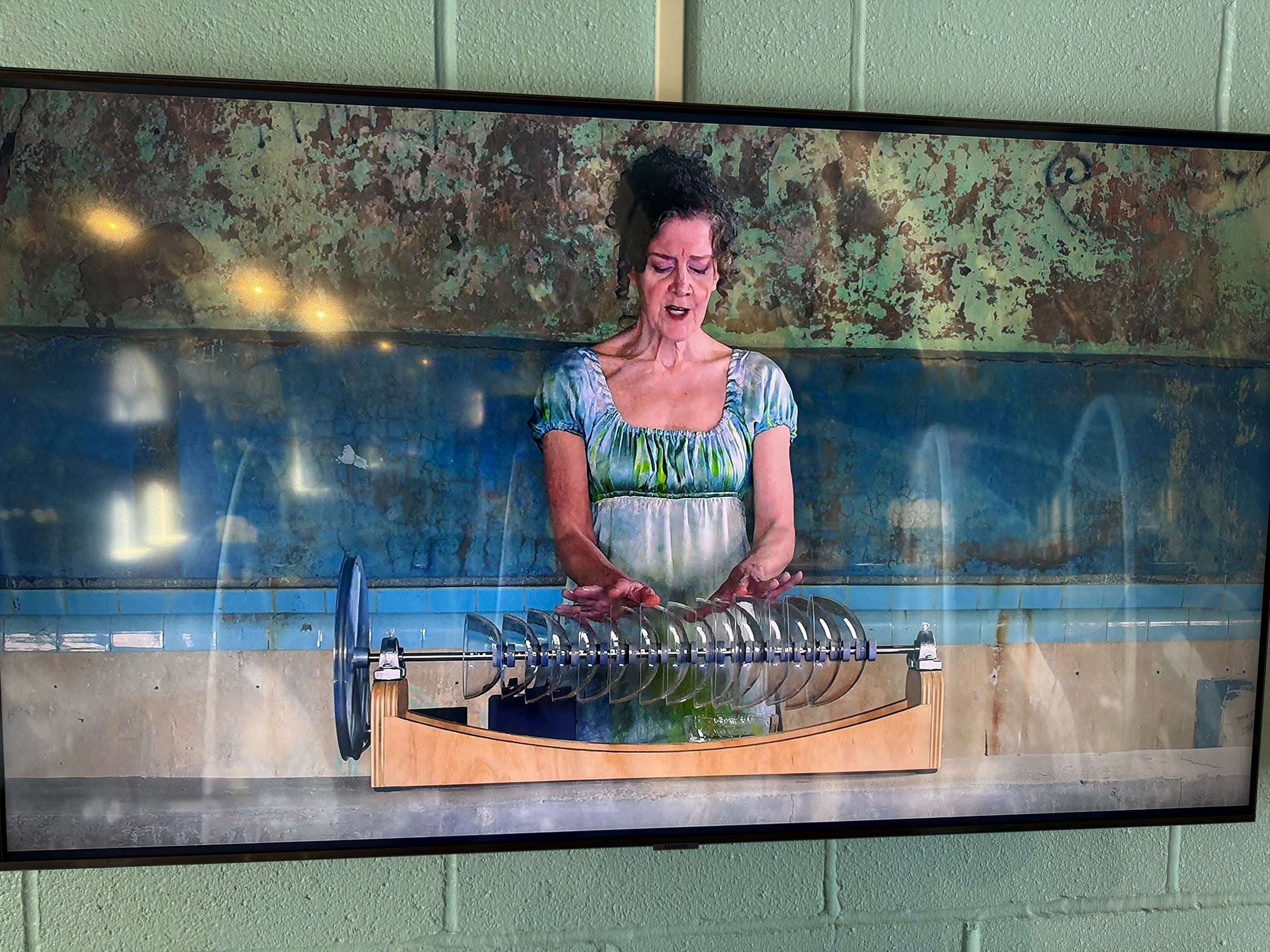 Musician Martha McDonald plays the glass armonica on a screen