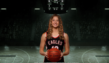 student holding basketball