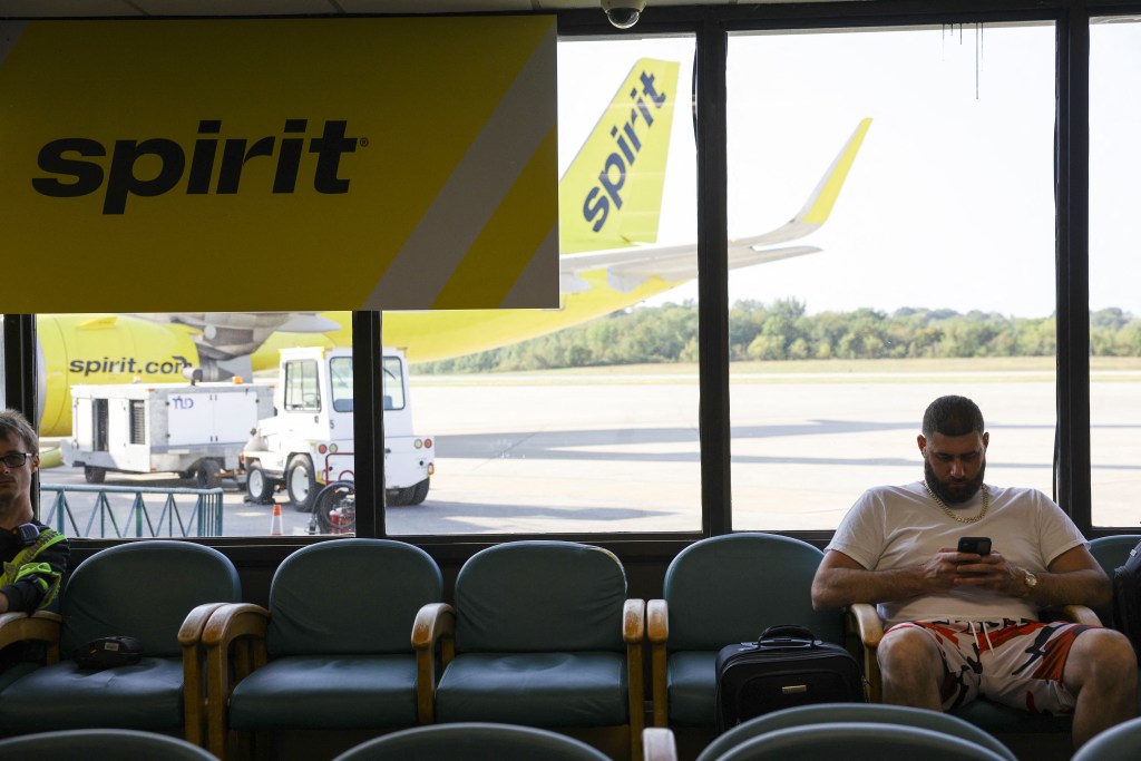 Passengers wait to board a Spirit Airlines flight at Arnold Palmer Regional Airport.