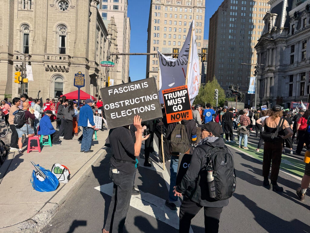 Unions and labor activists rally at City Hall to commemorate May Day