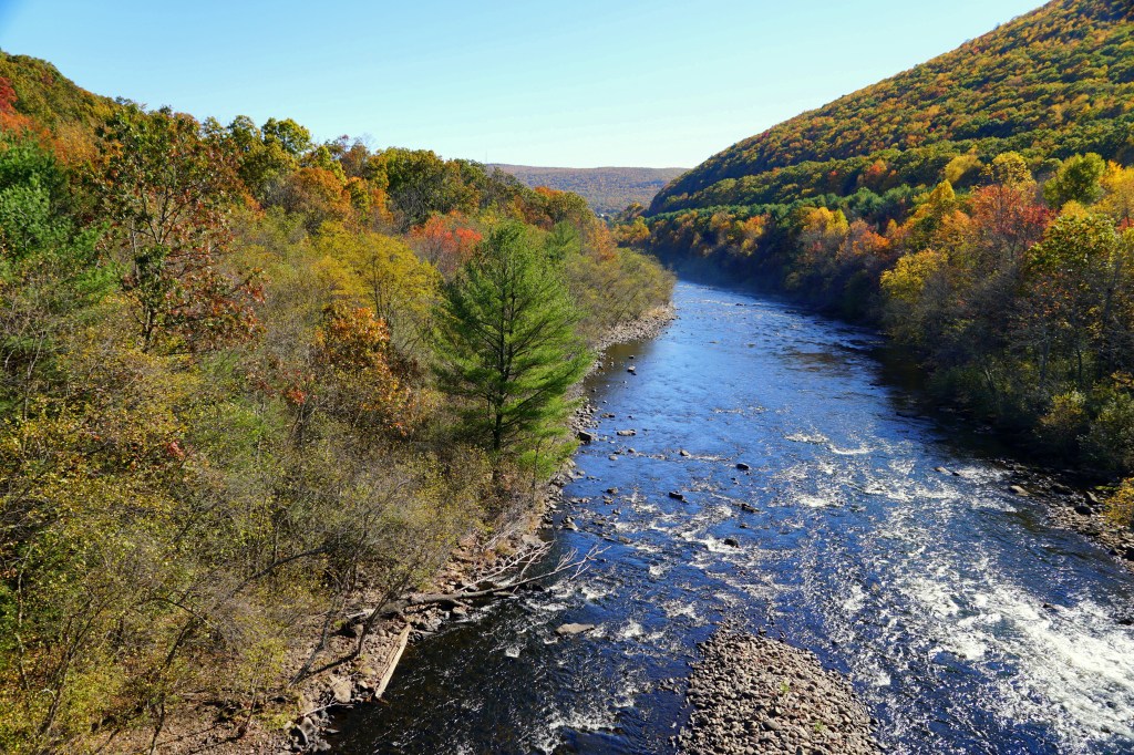 Lehigh River in Jim Thorpe, Pennsylvania, surrounded by vibrant fall foliage.