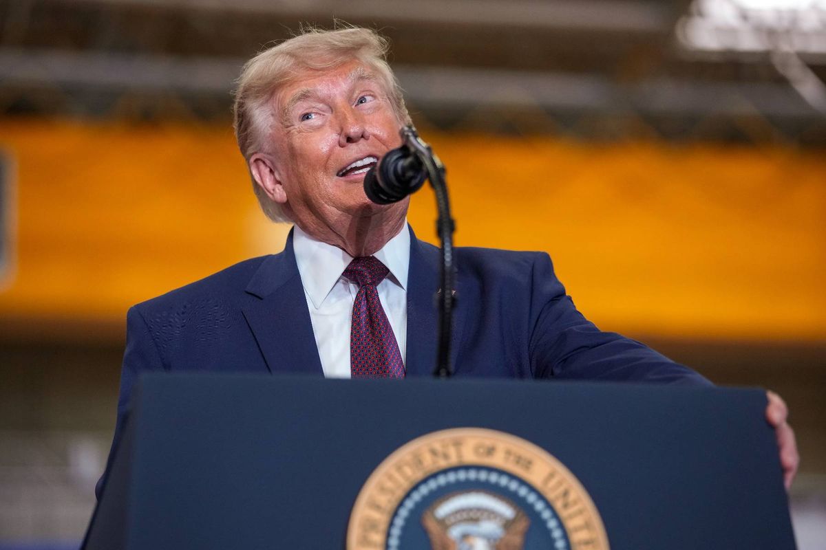 An individual in formal attire delivers a speech at a podium adorned with the emblem of the President of the United States, with a microphone positioned before him.