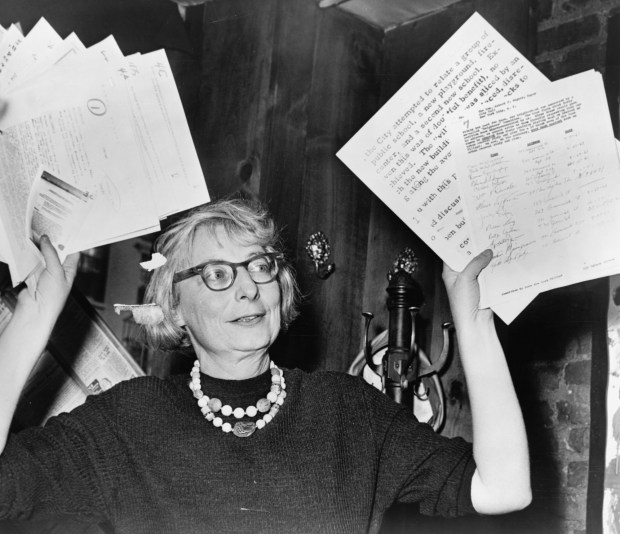 Jane Jacobs, then the leader of the Committee to Save the West Village, holds up documentary evidence at a press conference at the Lions Head restaurant in New York on Dec. 5, 1961. (U.S. LIBRARY OF CONGRESS PRINTS AND PHOTOGRAPHS DIVISION)