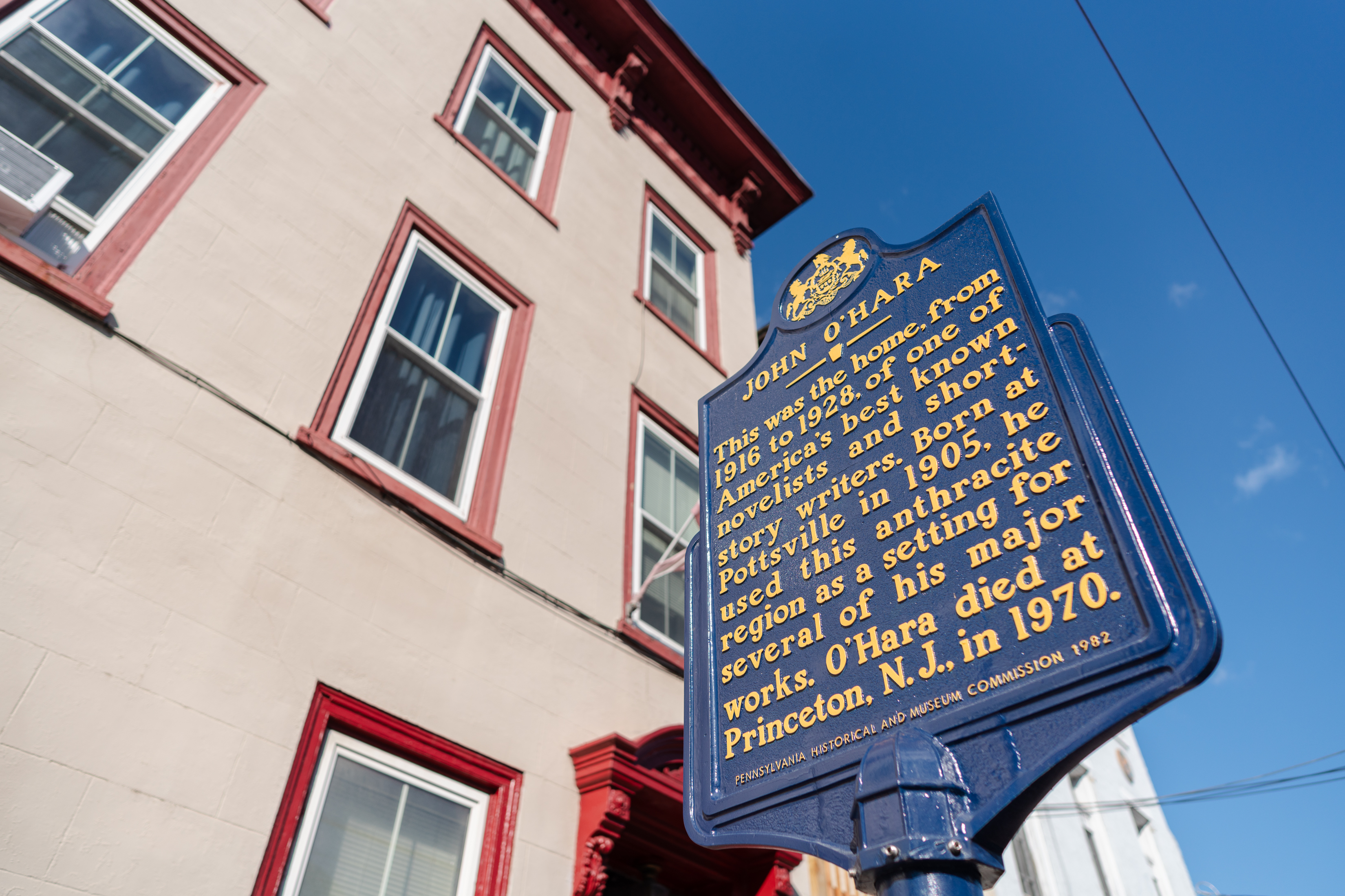 A historical plaque denotes the building next to it as...