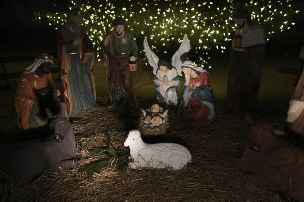 A Nativity scene is illuminated by a Christmas tree on Payrow Plaza in Bethlehem, Pa., known as “Christmas City, USA,” on Sunday, Dec. 1, 2024. (AP Photo/Luis Andres Henao)