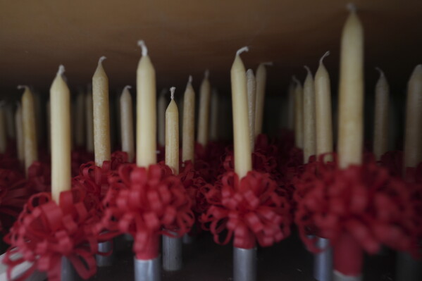 Handmade beeswax candles made by members of Central Moravian church are stored in a closet in Bethlehem, Pa., on Sunday, Dec. 1, 2024, in preparation to be lit during Christmas services. (AP Photo/Luis Andres Henao)