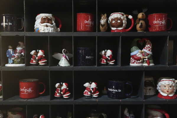 Christmas mugs and decorations on display at a store in Bethlehem, Pa., on Sunday, Friday, Nov. 29, 2024. (AP Photo/Luis Andres Henao)