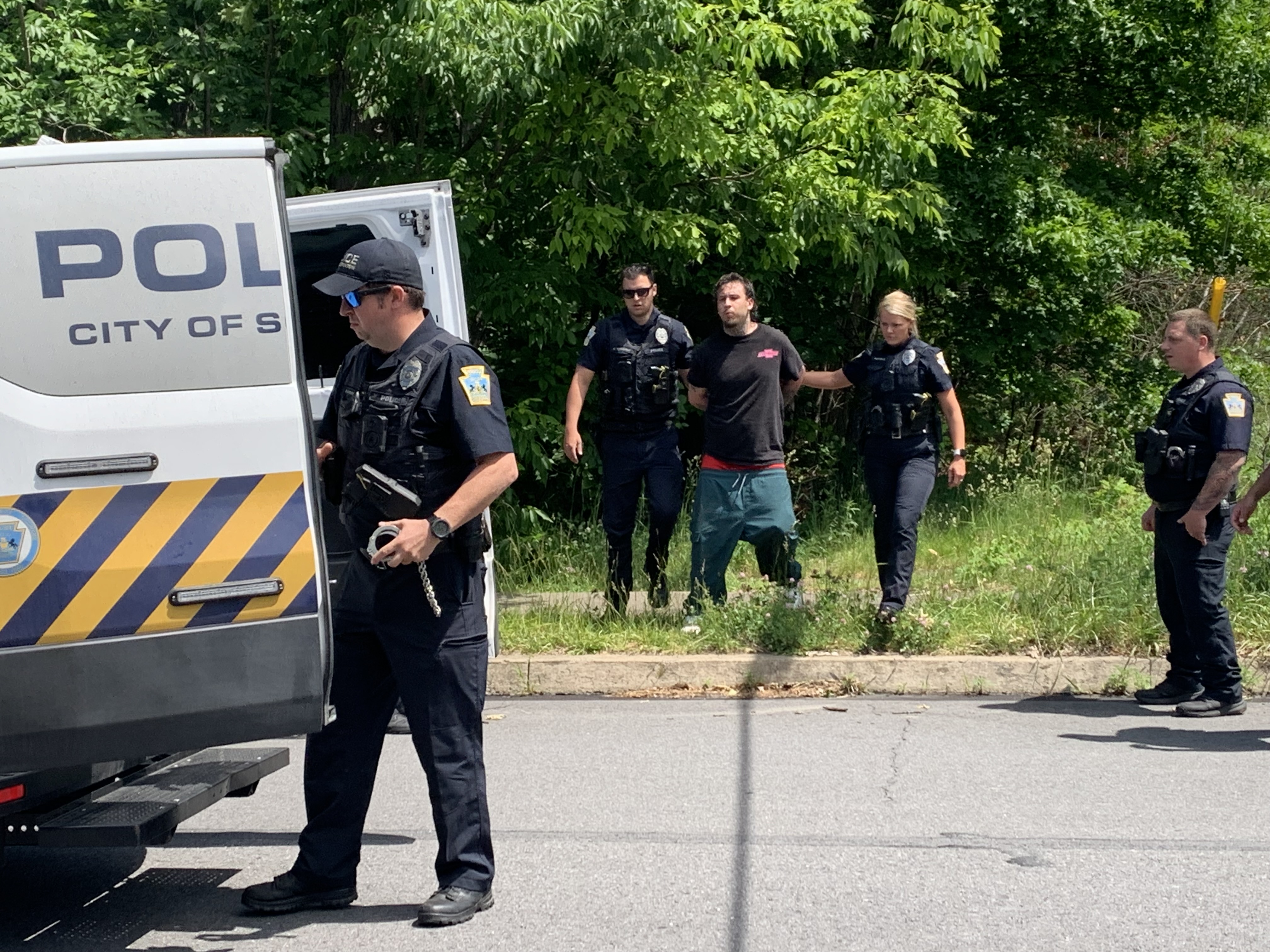 Scranton police apprehended a man, in black T-shirt, who ran...