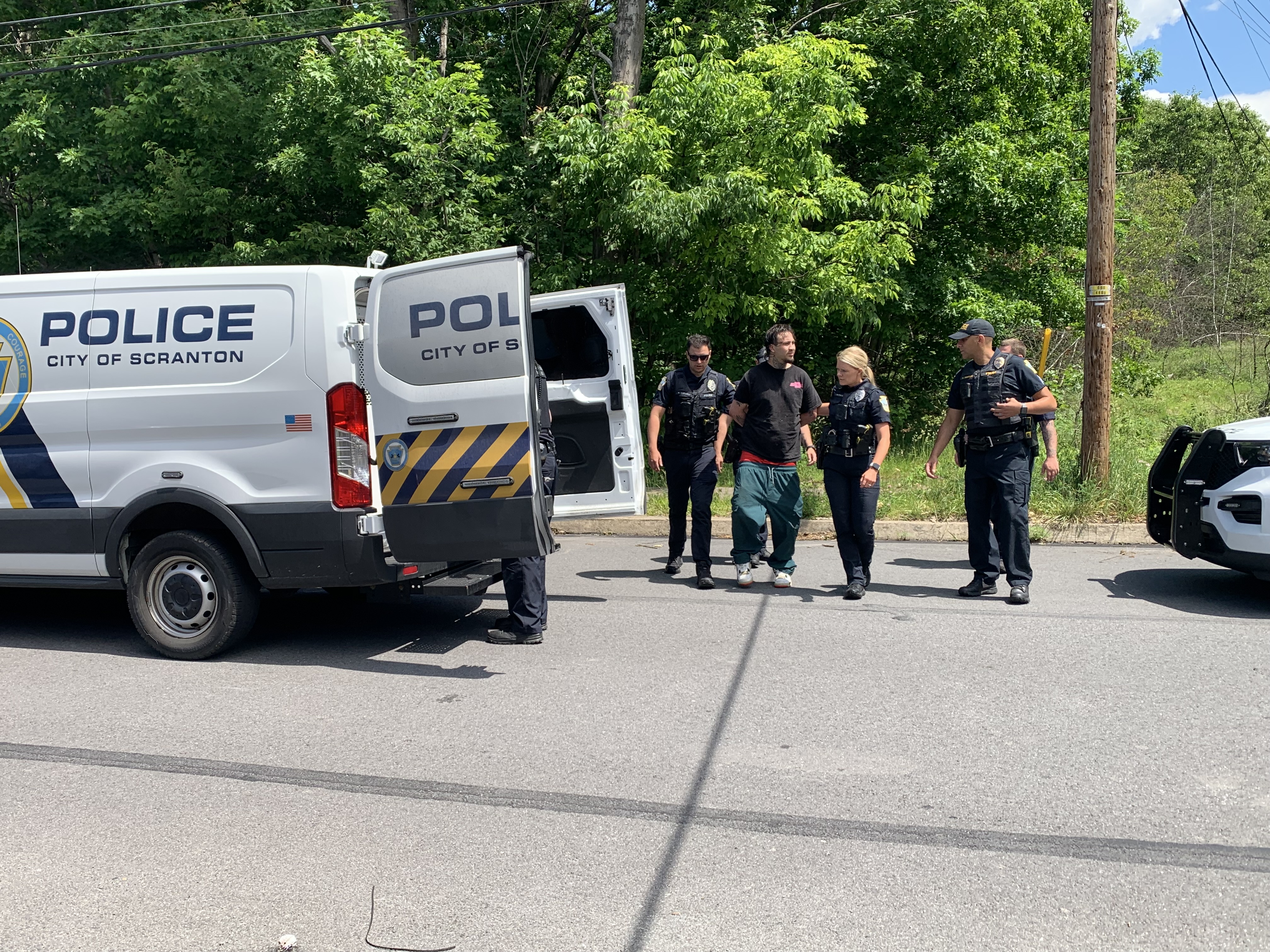 Scranton police apprehended a man, in black T-shirt, who ran...