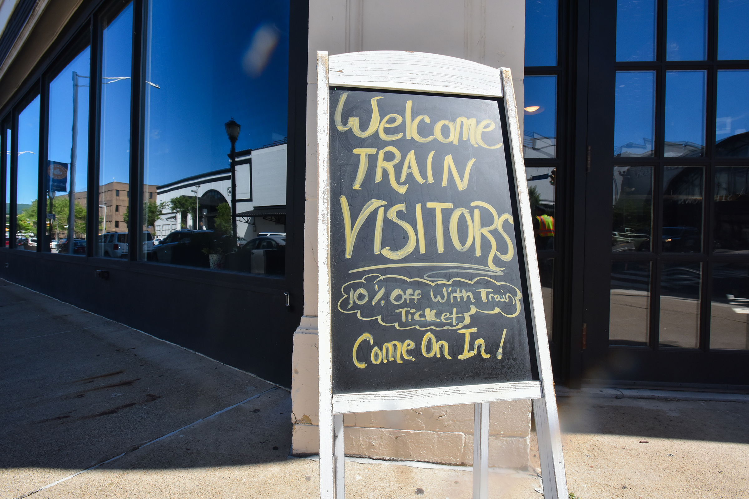 A sign outside of Black and Brass Coffee offers discounts...