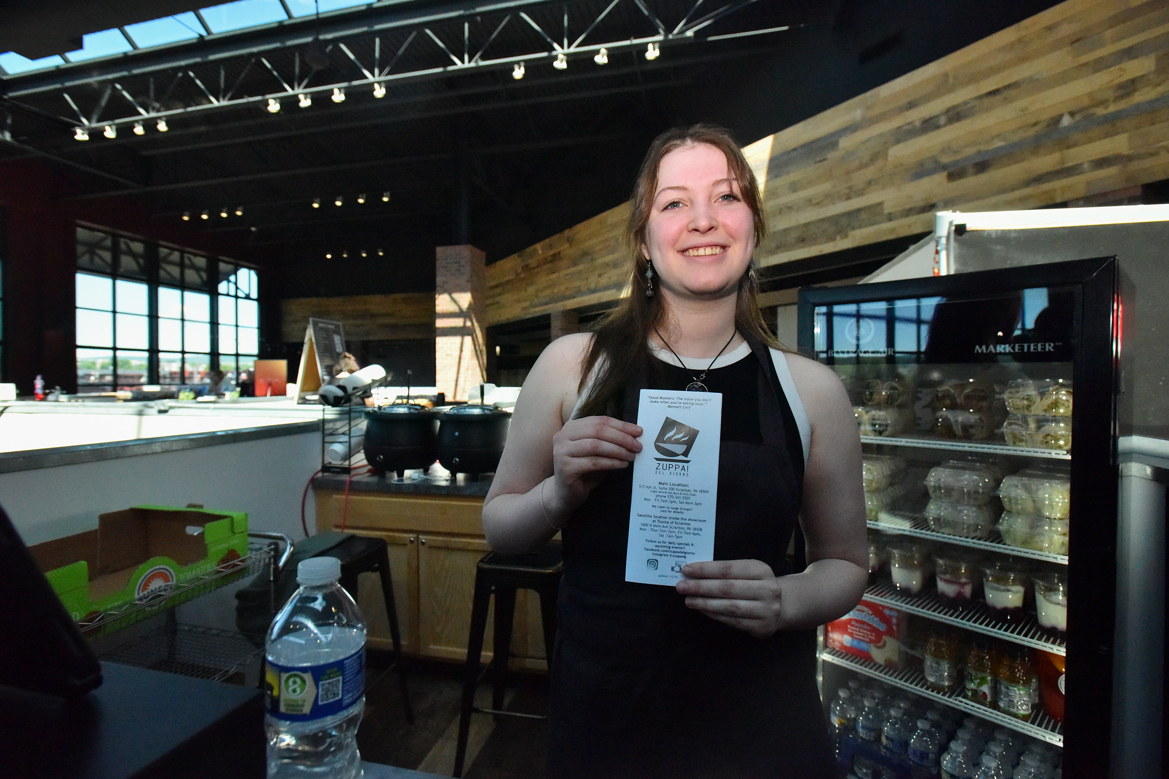 Employee of Zuppa Del Giorno Harlie Jones poses for a...