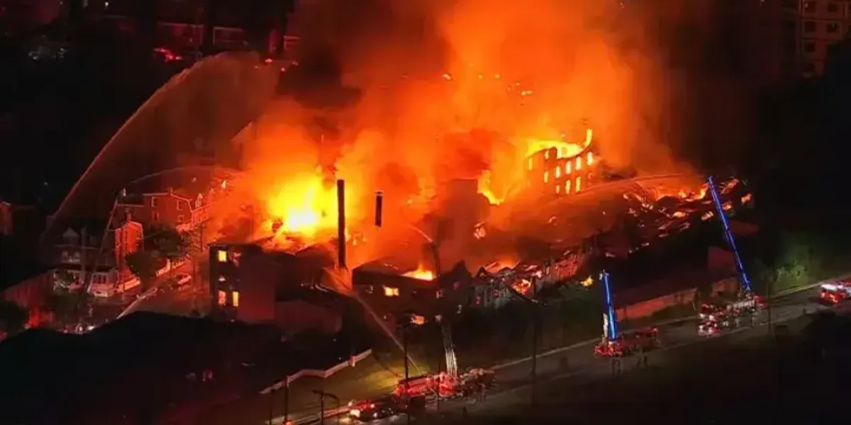 Massive fire engulfs Allentown warehouse and multiple row homes