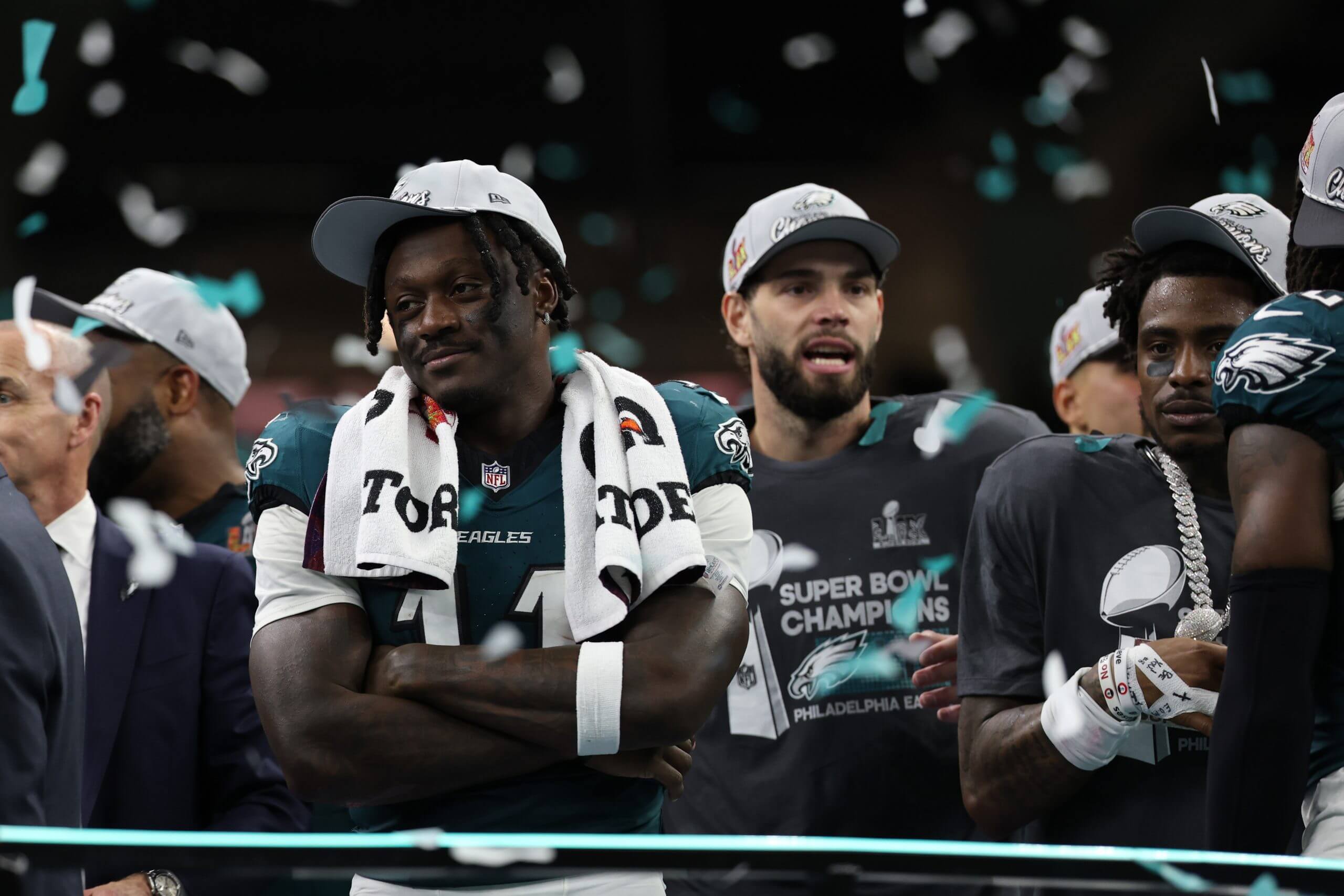 Philadelphia Eagles wide receiver A.J. Brown (L) stands on the stage during the championship trophy presentation after the Eagles' game against the Kansas City Chiefs in Super Bowl LIX at Caesars Superdome.