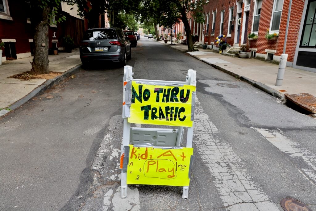 Homemade traffic signs hanging up on the street.