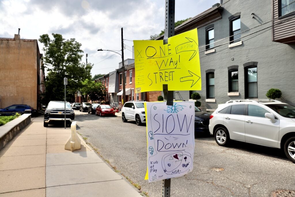 Homemade traffic signs hanging up on the street.