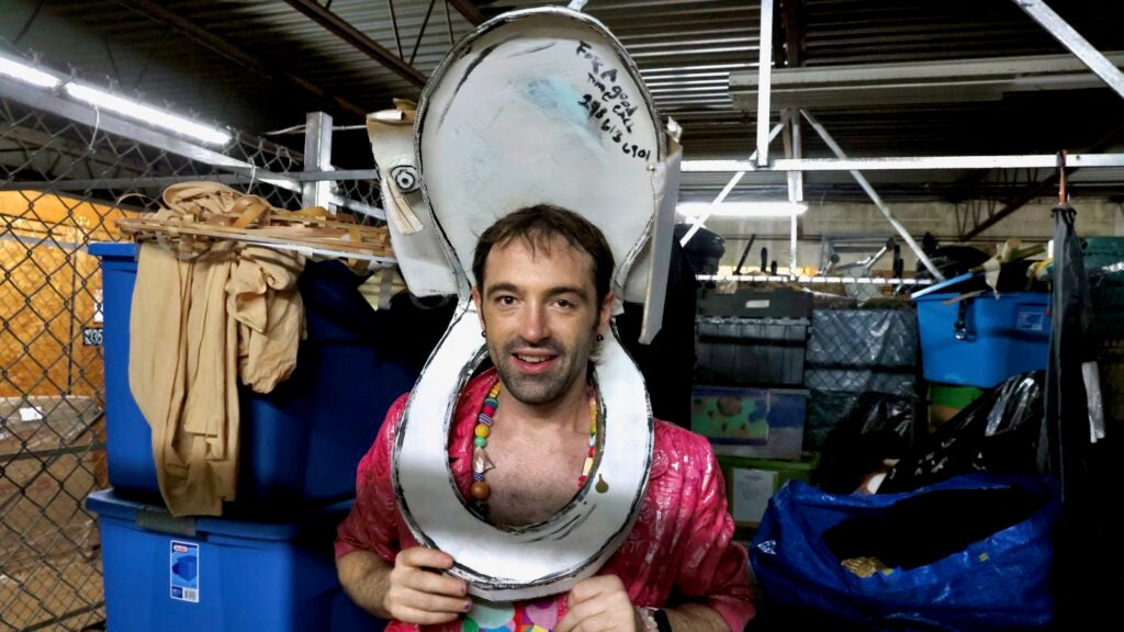 Rose Jarboe of the Bearded Ladies Cabaret tries on the cardboard toilet