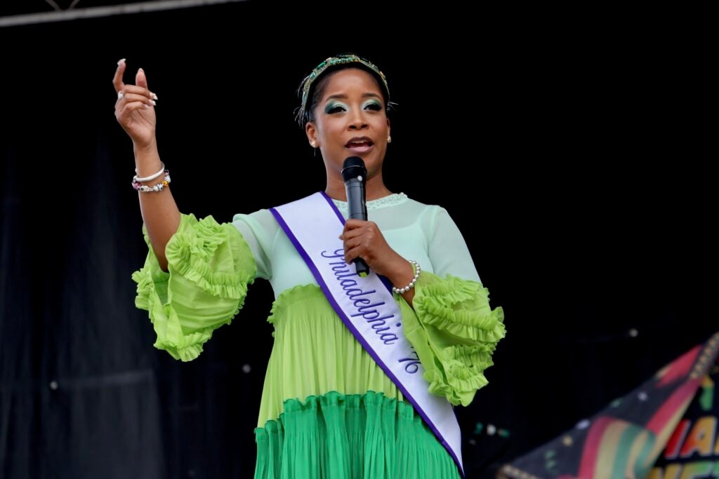 Ashley Jordan speaking into a microphone on stage.