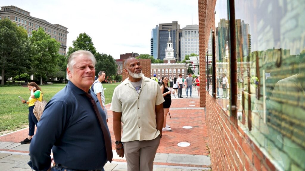 Kevin Douglass Green and Brian Evans pose for a photo at the President's House exhibit.