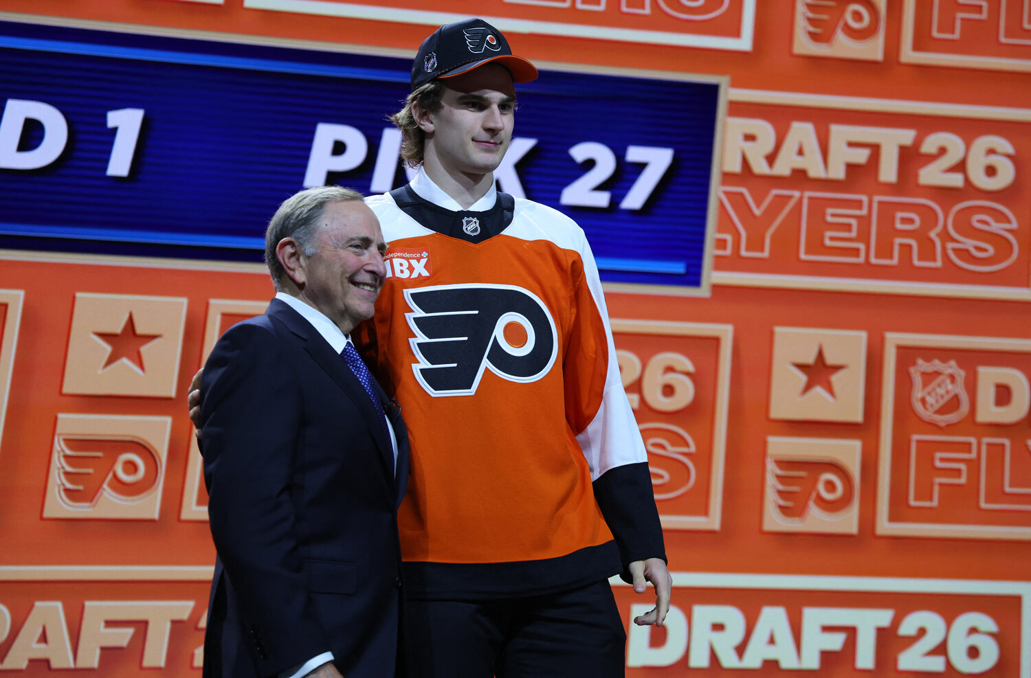 Jun 26, 2026; Buffalo, New York, USA; Maksim Sokolovskii reacts beside NHL commissioner Gary Bettman after being selected with the twenty seventh pick in the first round of the 2026 NHL Draft by the Philadelphia Flyers at KeyBank Center.