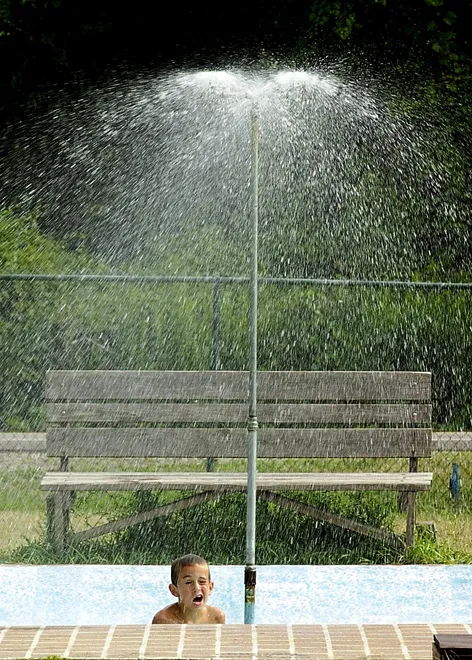Russell Blumish, of Harborcreek Township, enjoys the cool shower at Whitford Park, 5400 Iroquois Ave., in August 2001.