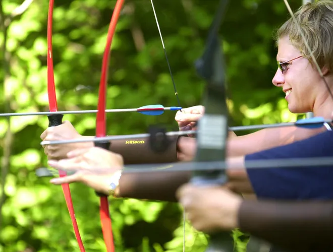 North East resident Heidi Schenker learns archery during the Women in the Outdoors seminar at the Lake Edinboro Sportsmen Club on Aug. 11, 2001.