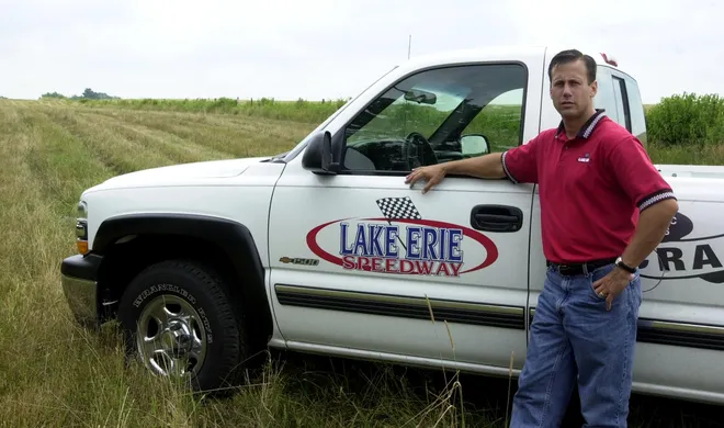 Todd Melfi, general manager of Lake Erie Speedway, stands on the site at 10700 Delmas Drive in North East where speedway construction began in August 2001.
