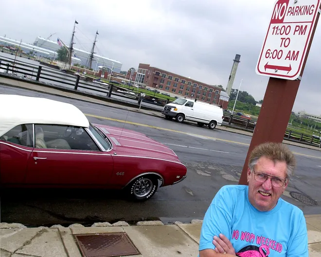 Kenny Everall, a member of the Lake Erie Classic Car Club, poses with his car at Dobbins Landing in August 2001, when Erie police started to enforce regulations against parking after 11 p.m., putting a crimp in the tradition of buggin' State.