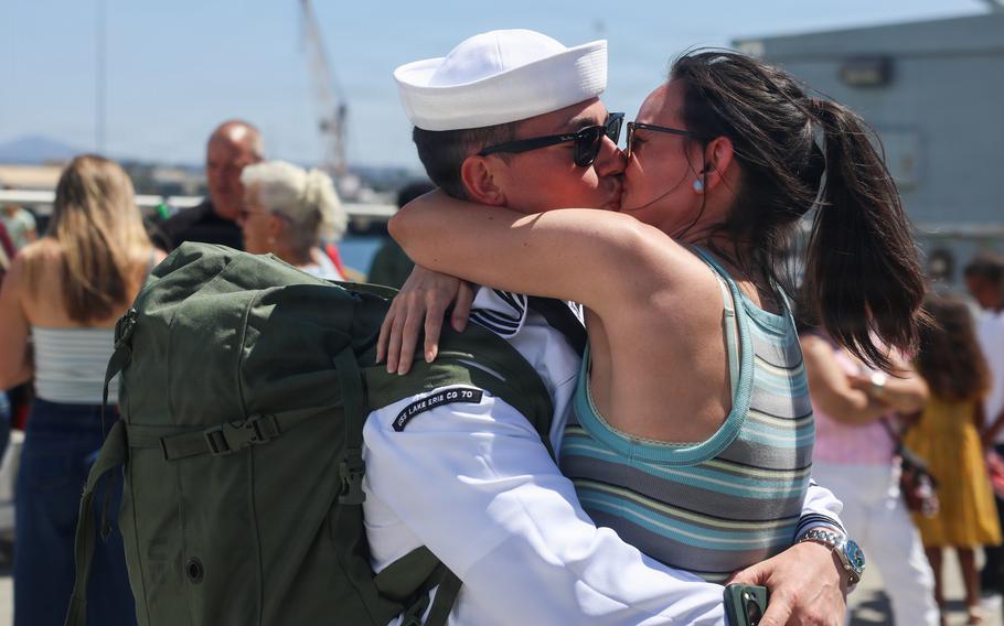 Williams embraces and kisses a woman.
