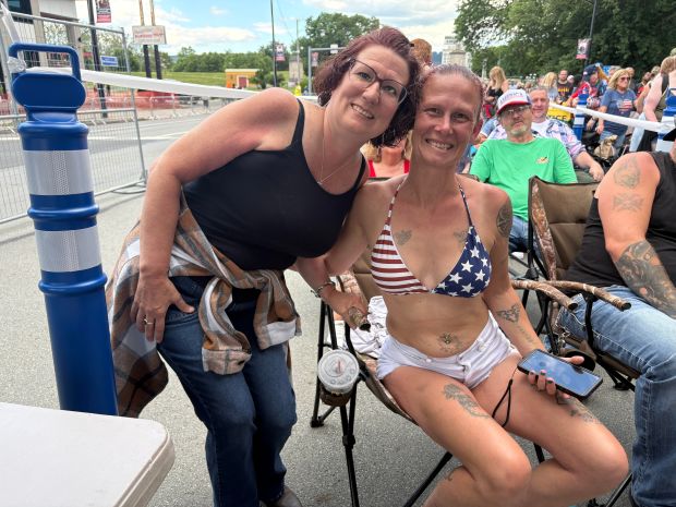 Concertgoers, including Lorelei Young of Altoona, right, and Sarah Walsh of Scranton, wait in line for the America 250 celebration at Kirby Park in Wilkes-Barre. BOB KALINOWSKI / STAFF PHOTO
