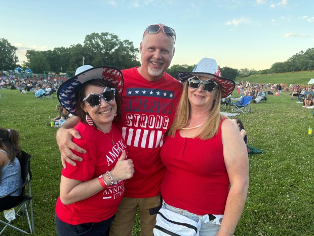 A group of friends, Mary Wenger, 51, of Swoyersville, left, Ed Marchessault, 56, of Lehighton, center, and Trisha Wildey, 50, of Luzerne, right, dressed in patriotic attire for the America250PA concert featuring Lady A and En Vogue. (Bob Kalinowski / Staff Photographer)