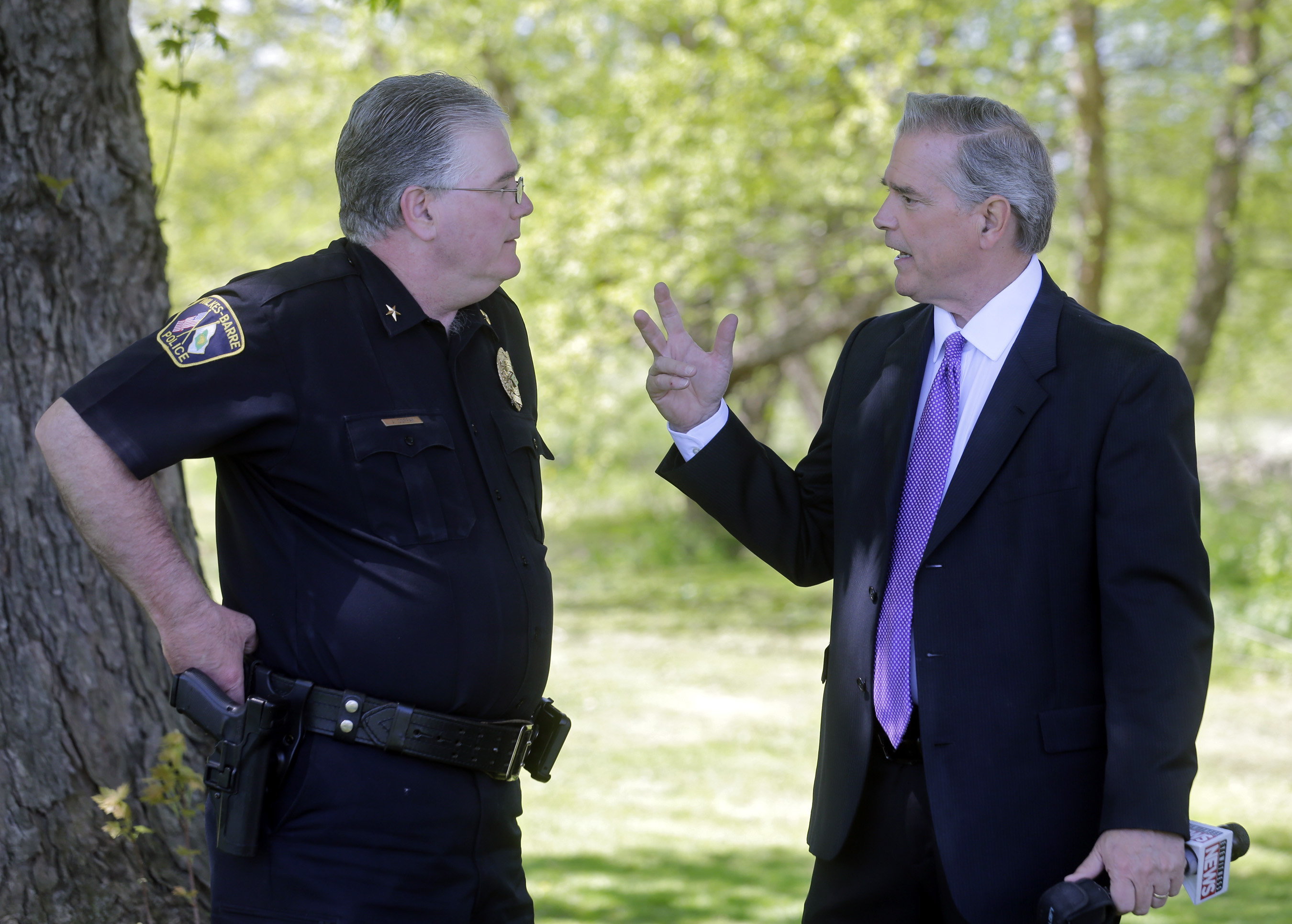 WBRE-TV investigative reporter Andy Mehalshick, right, talks with Wilkes-Barre Police...