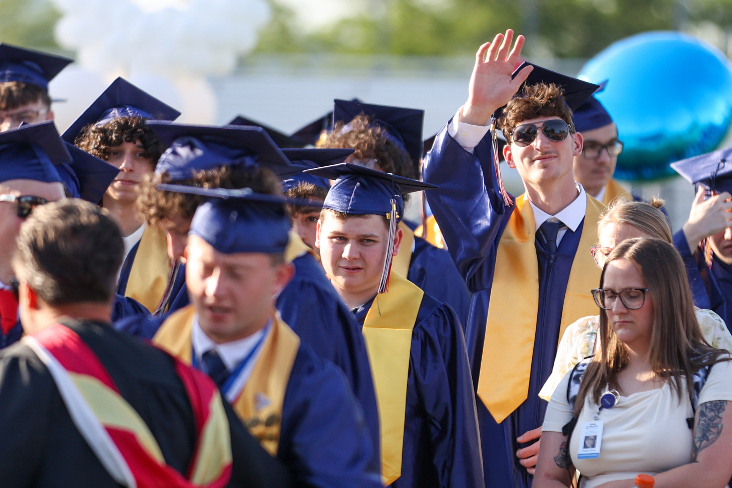 Soon-to-be graduates wave to loved ones during the 60th annual...