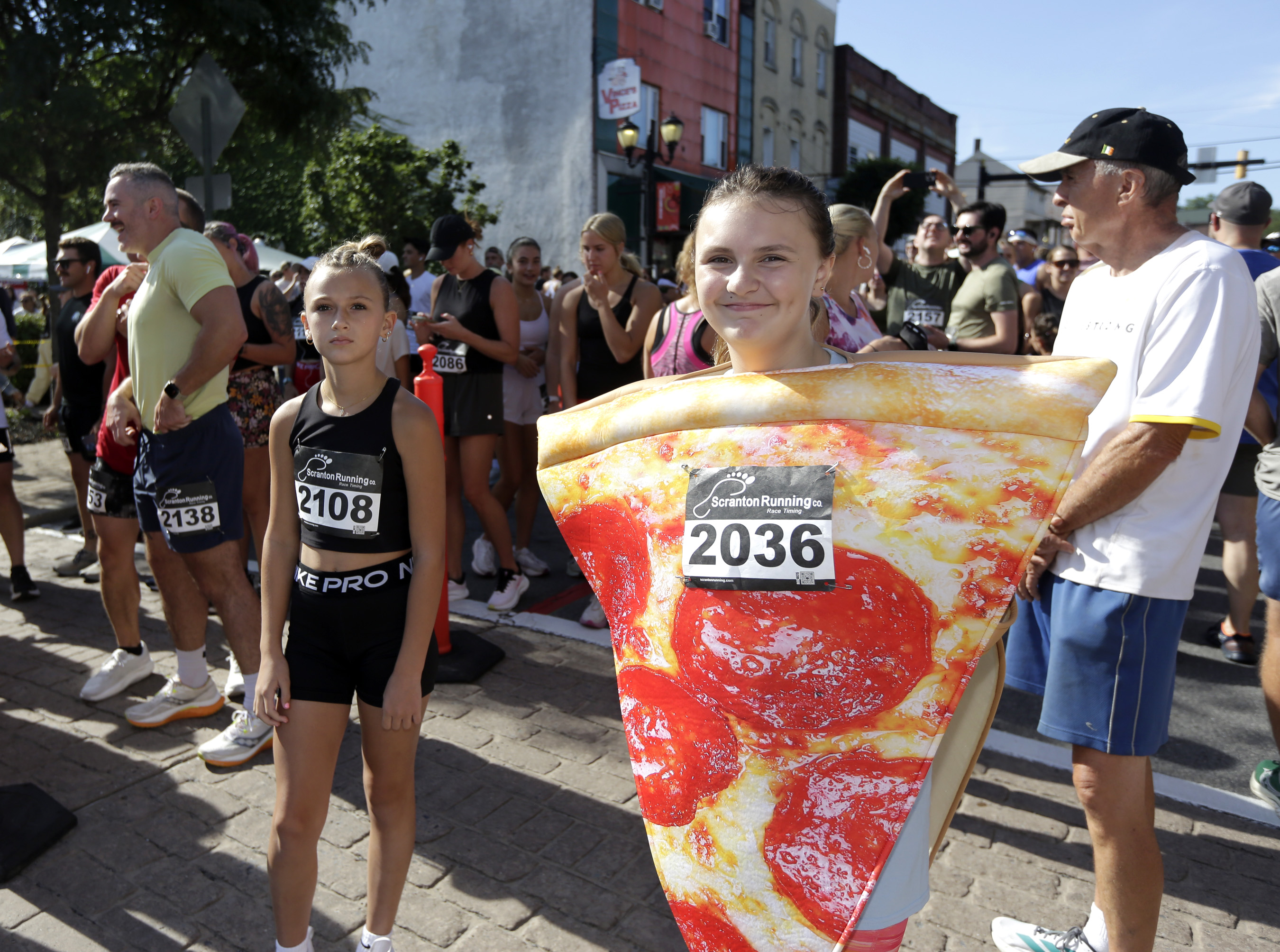 Trinity Miller, of Pittston, dresses as a pizza slice for...
