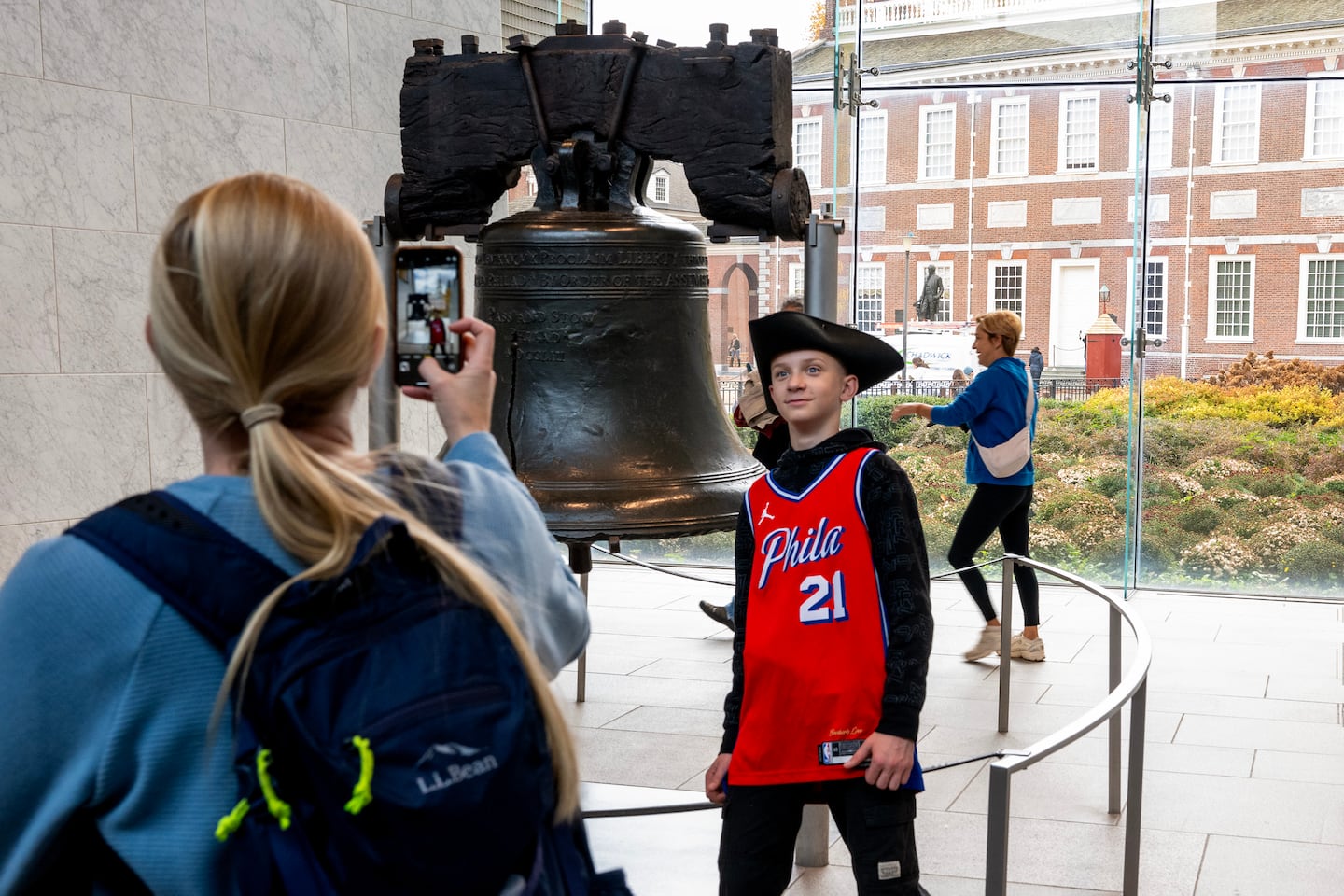 Amanda Williams photographs her son Corwin, 13, in front of Liberty Bell in Independence National Historical Park.