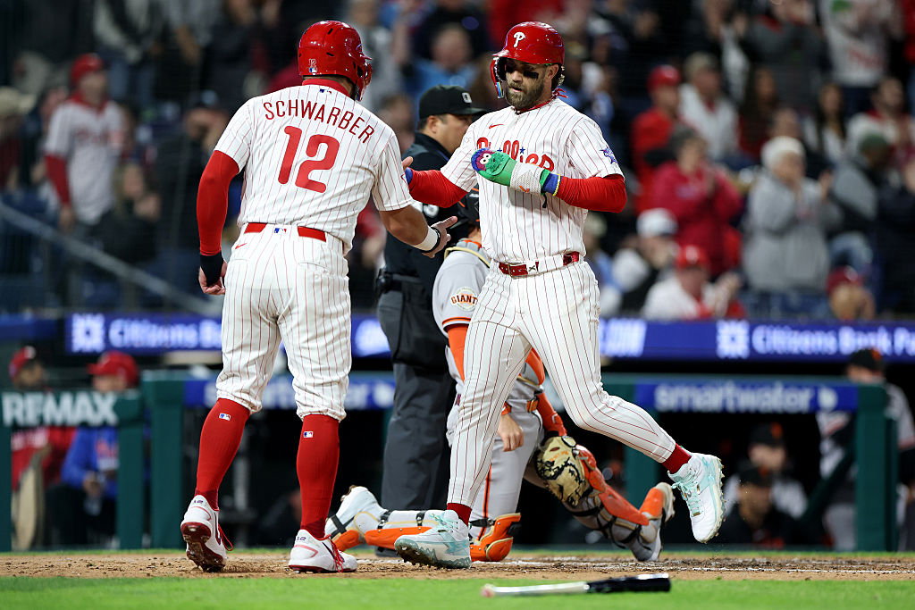 PHILADELPHIA, PENNSYLVANIA - APRIL 28: Bryce Harper #3 and Kyle Schwarber #12 of the Philadelphia Phillies celebrate scoring on a two-RBI double by Adolis García #53 (not pictured) in the sixth inning during a game against the San Francisco Giants at Citizens Bank Park on April 28, 2026 in Philadelphia, Pennsylvania. (Photo by Emilee Chinn/Getty Images)